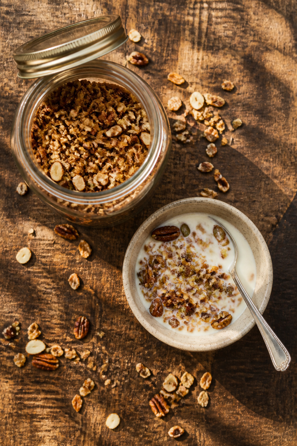 Homemade keto granola in a jar, featuring pecans and pumpkin seeds.