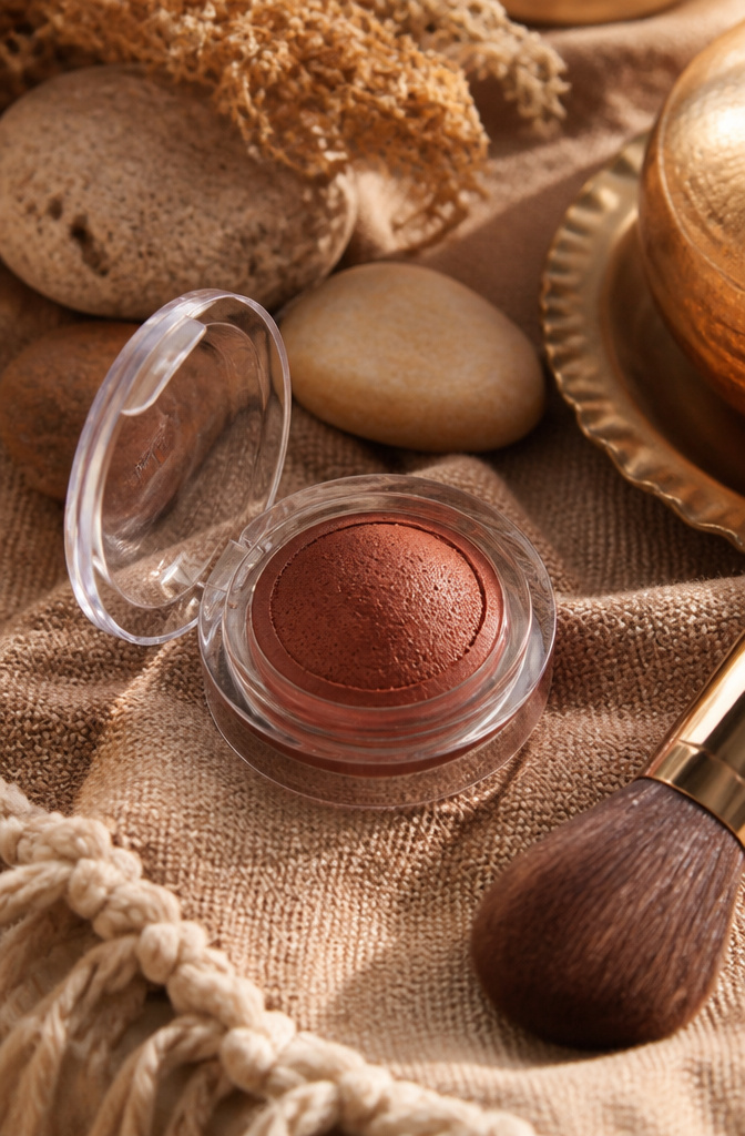 Brown Blush Makeup: 20 Best Picks for 2026 20 MAC Glow Play Cushiony Blush in a decorative setting with textiles.