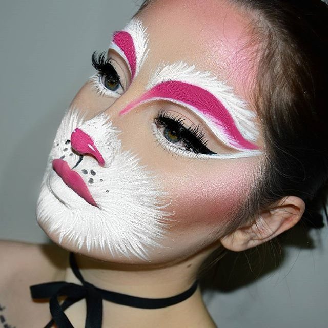 Person with bunny face makeup featuring a pink nose and white muzzle paint.