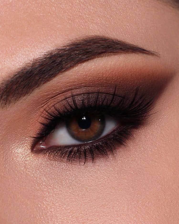 Close-up of an eye with dark brown smokey eyeshadow and black eyeliner.