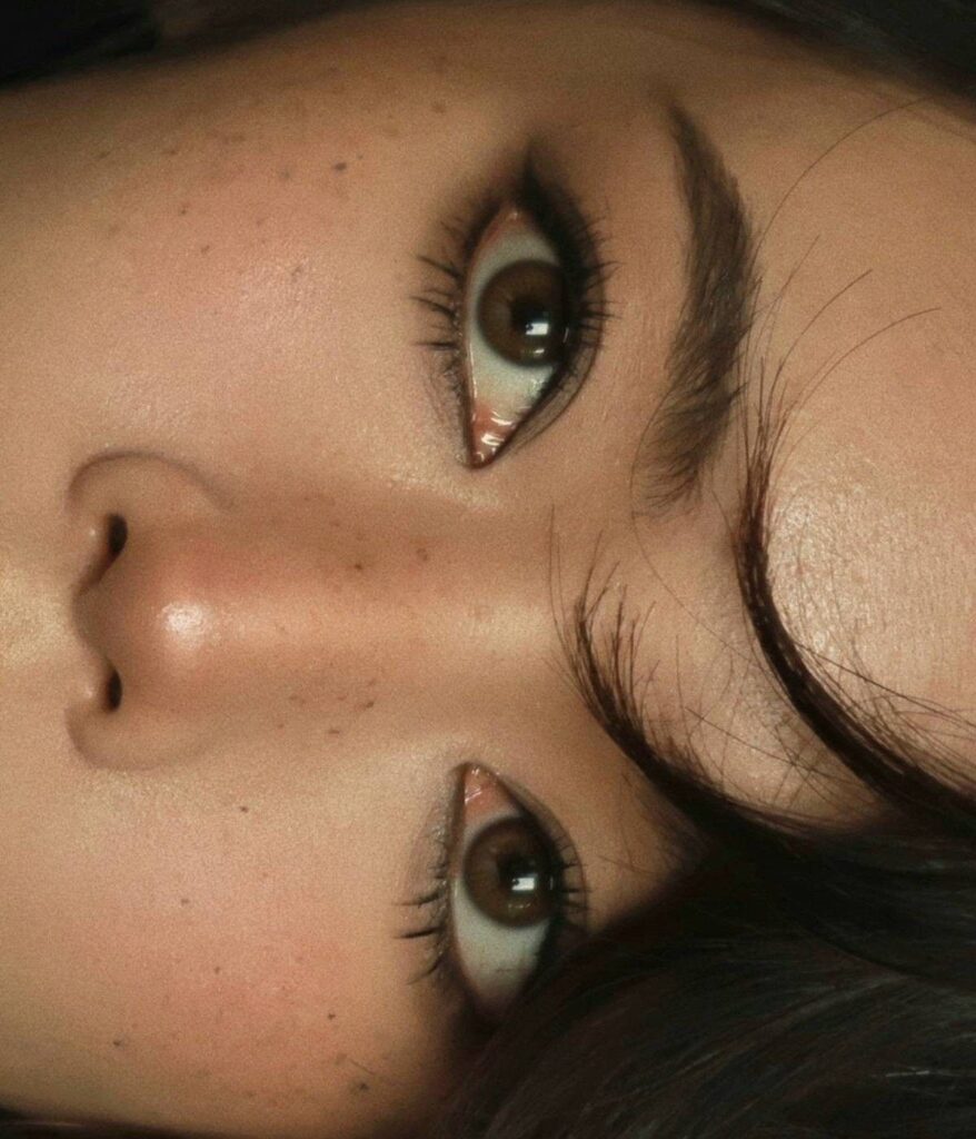 Monolid eyes with sharp black winged eyeliner and long dark eyelashes.