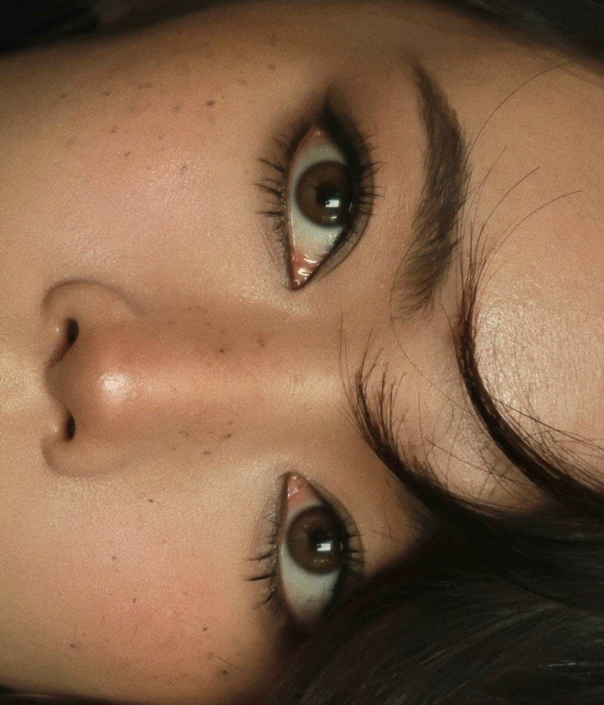 Monolid eyes with sharp black winged eyeliner and long dark eyelashes.
